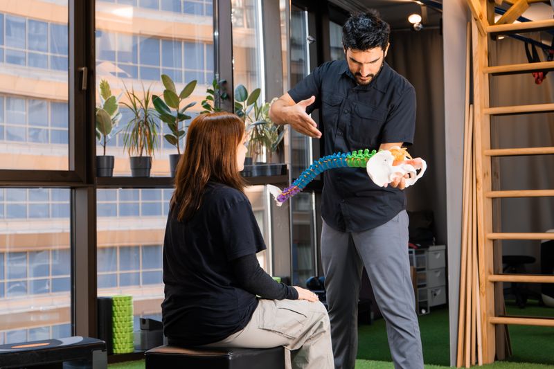 Chiropractor demonstrating spine anatomy to a patient