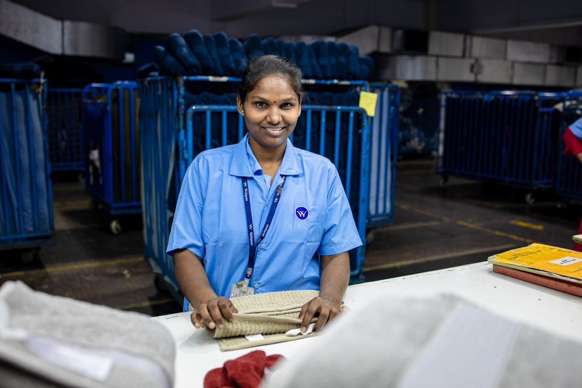Female factory worker smiles