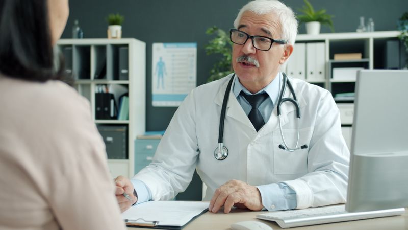 Experienced doctor consulting a patient in a medical office setting