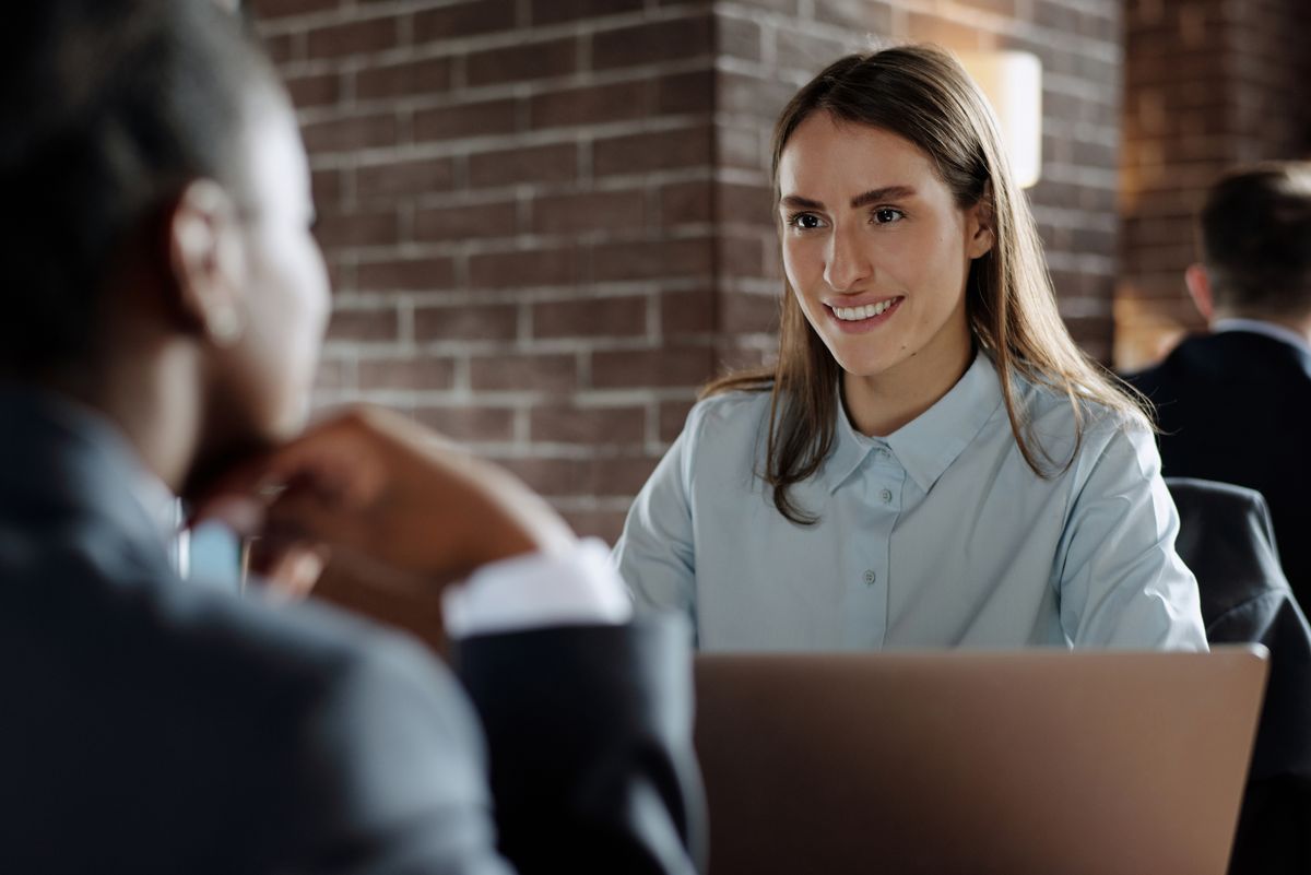 Professional business meeting with smiling individuals engaged in discussion