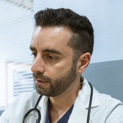 Doctor discusses health records with a patient in a clinical setting