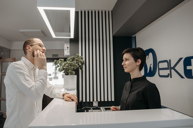 Patient discussing dental issues at a modern clinic reception