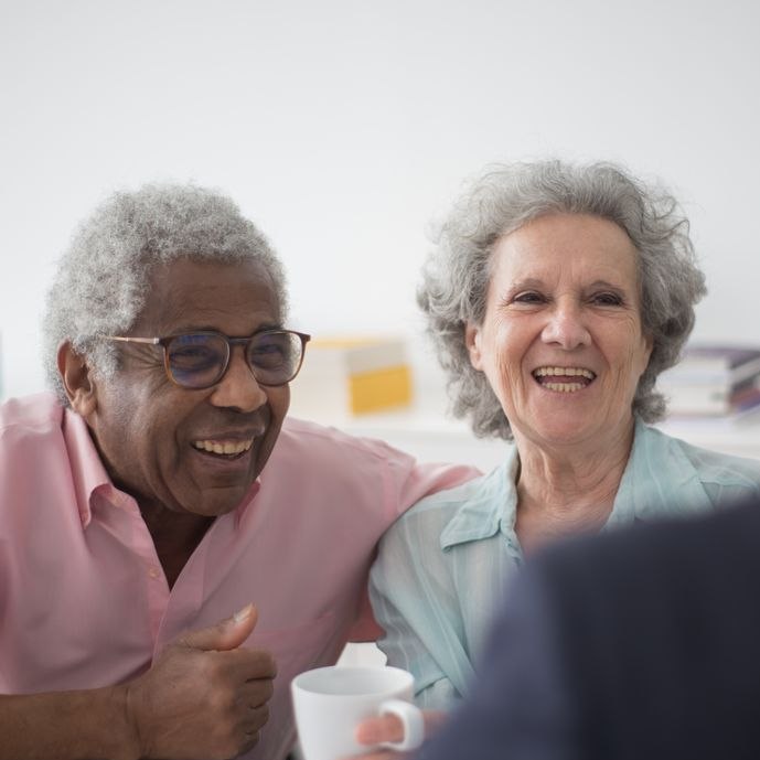 An elderly couple in conversation with a professional advisor