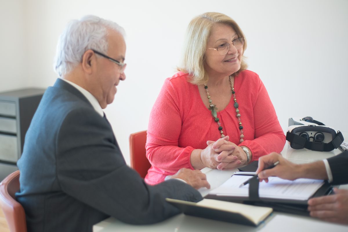 Elderly couple with real estate agent